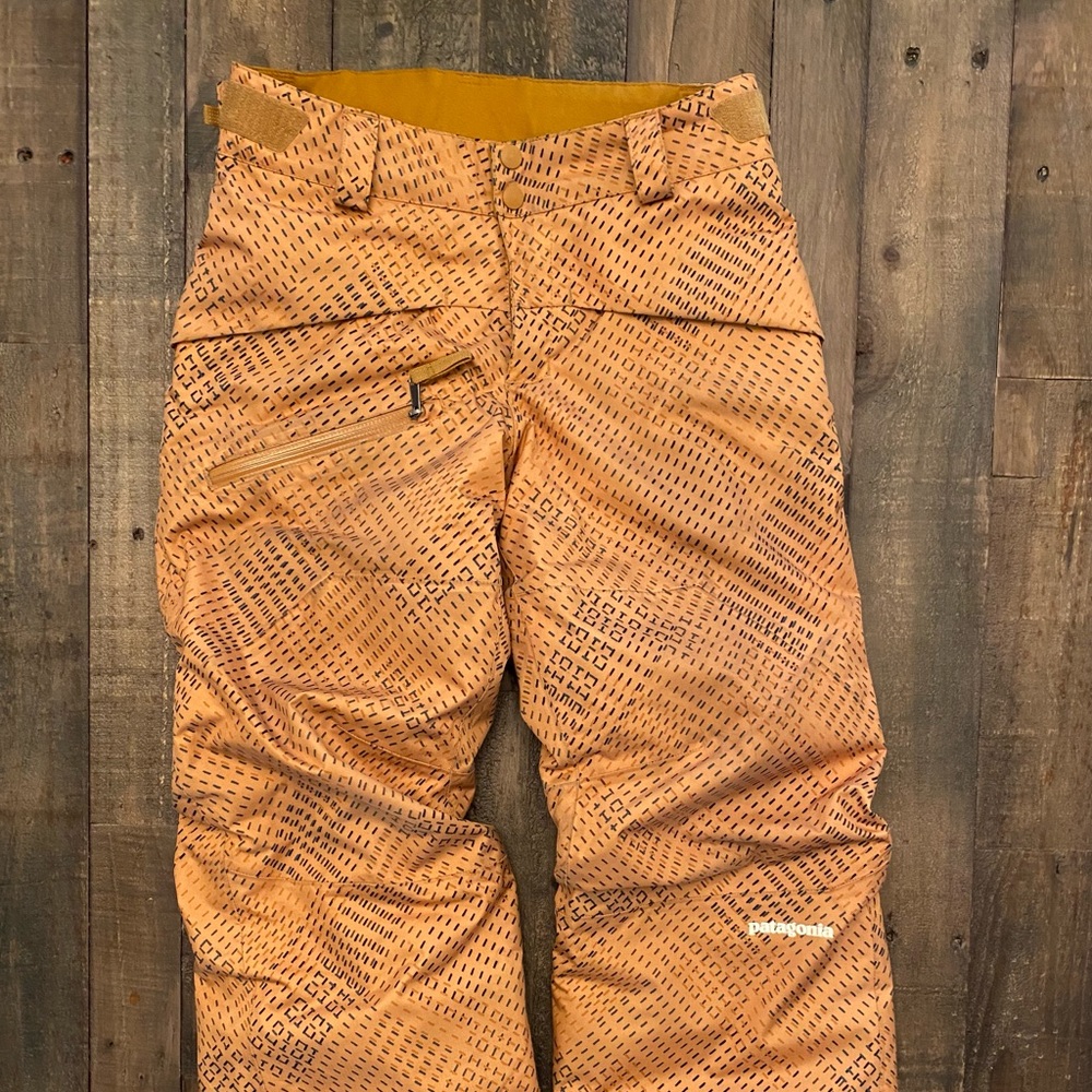 Boys Patagonia “snow shot” snow pants, in gold.
